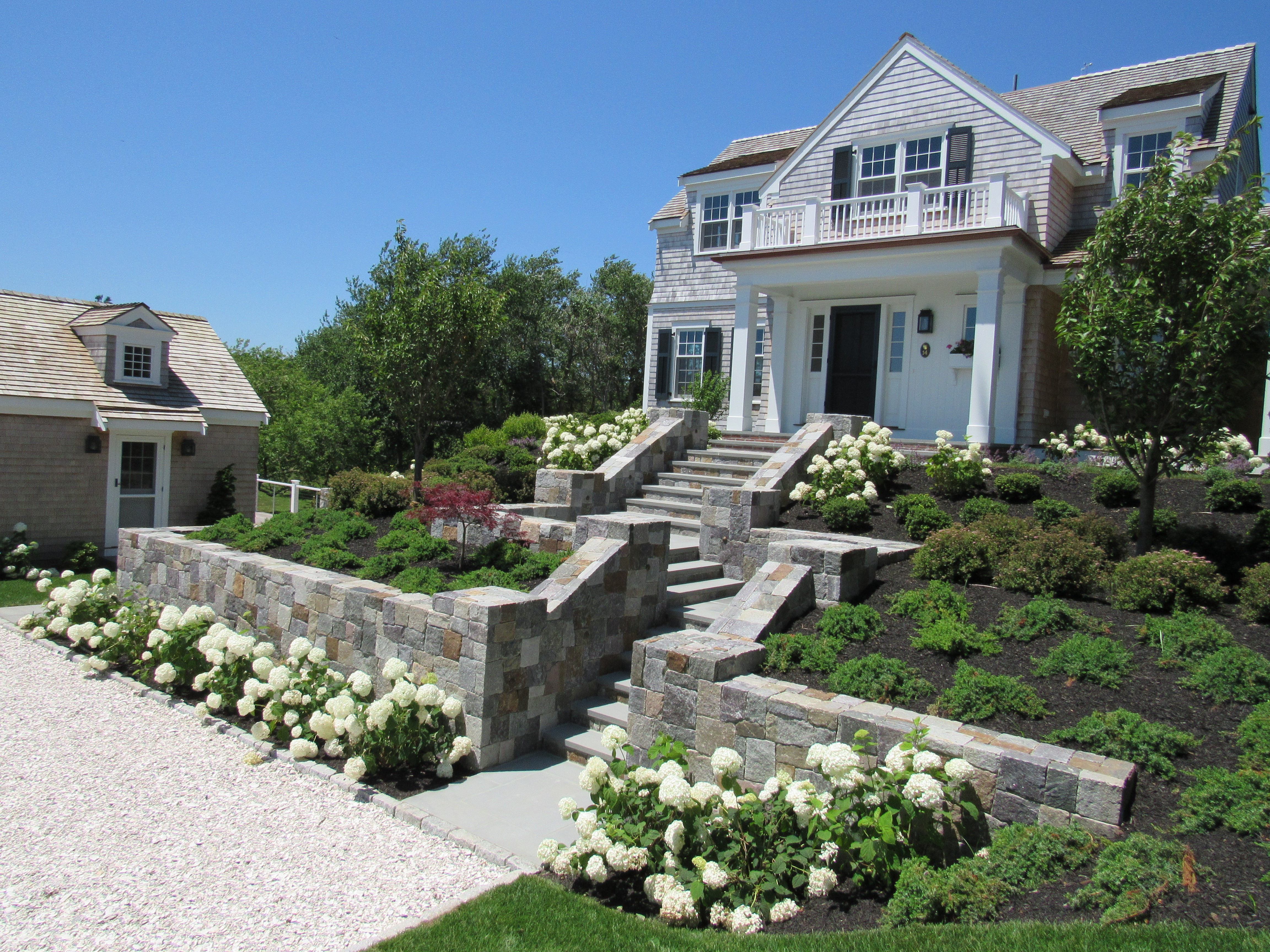 side view of driveway and stairs with hydrangeas